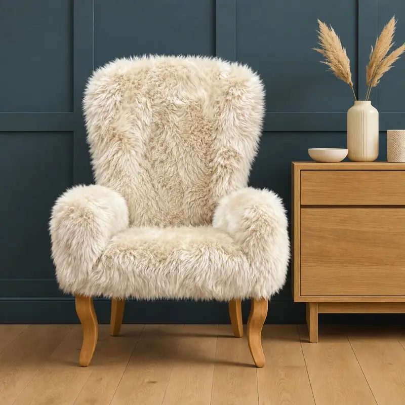 Nancy Sheepskin Armchair in seashell on a teal background.