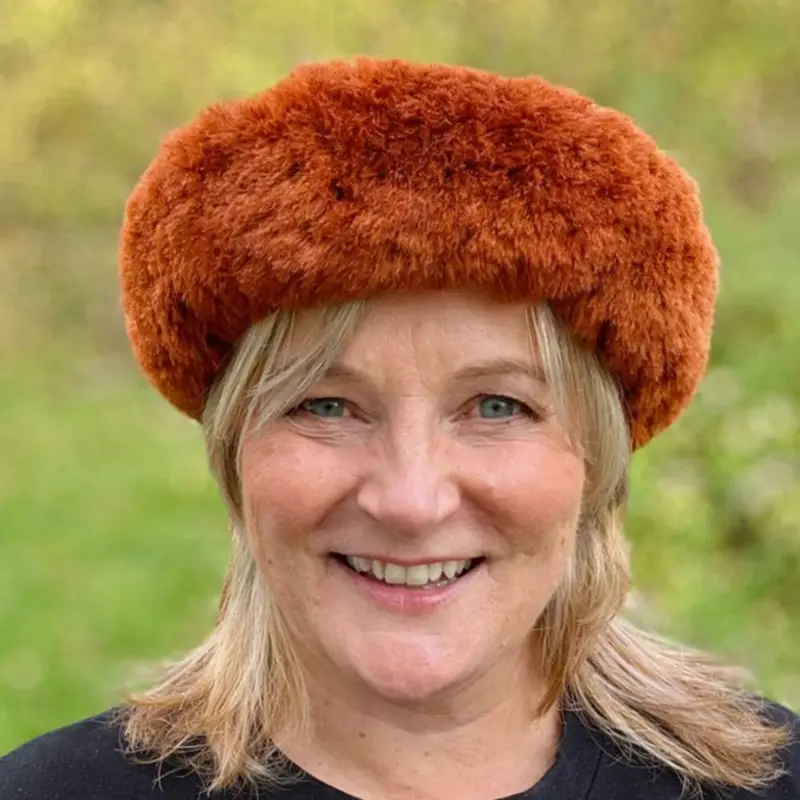 Michelle from Baa Stool wearing an orange sheepskin headband