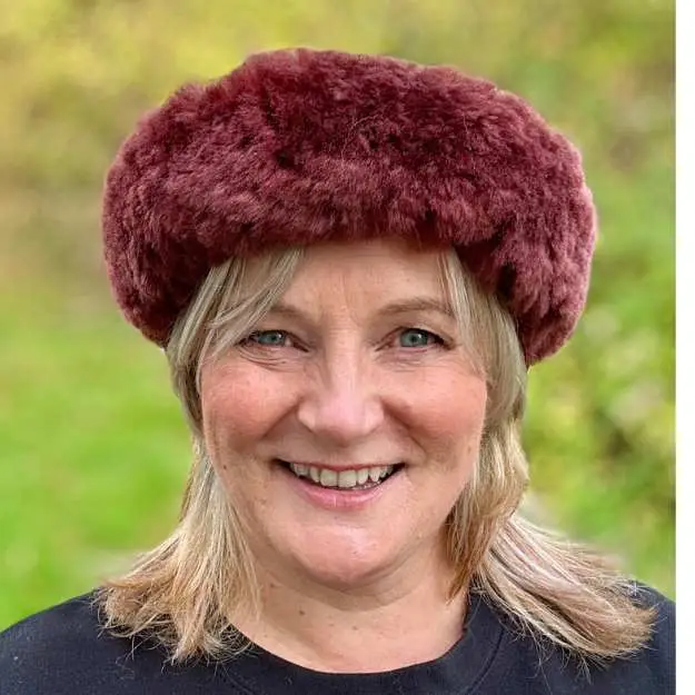 Michelle from Baa Stool wearing a plum coloured sheepskin headband