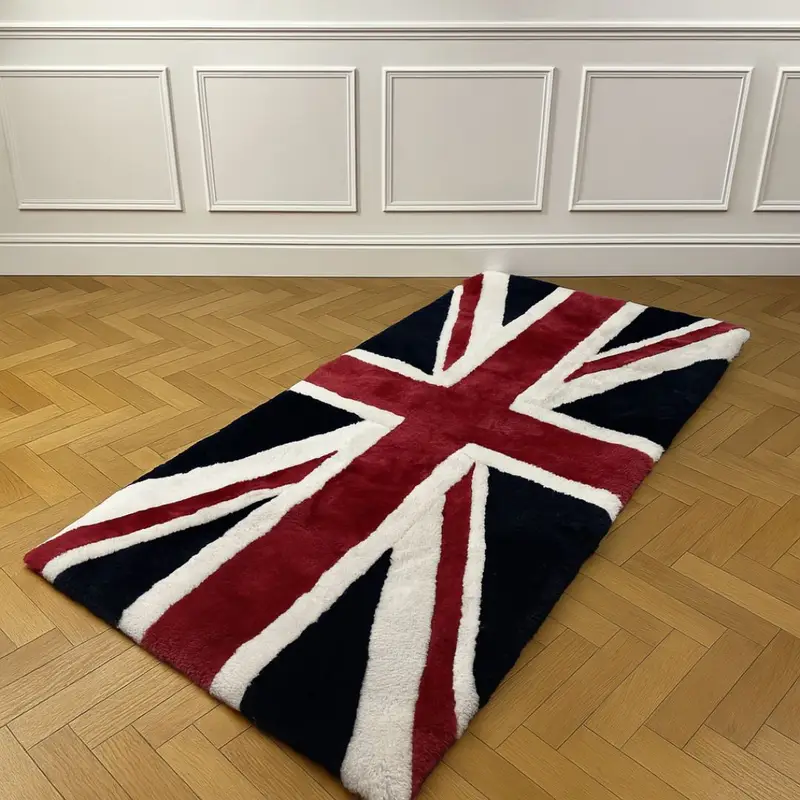 A large sheepskin rug in the style of a red, white and blue union jack rug on an oak floor with a white wall behind.