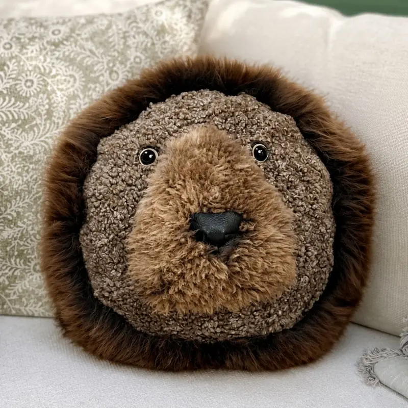 Woolly Wild brown bear sheepskin cushion on a cream sofa.