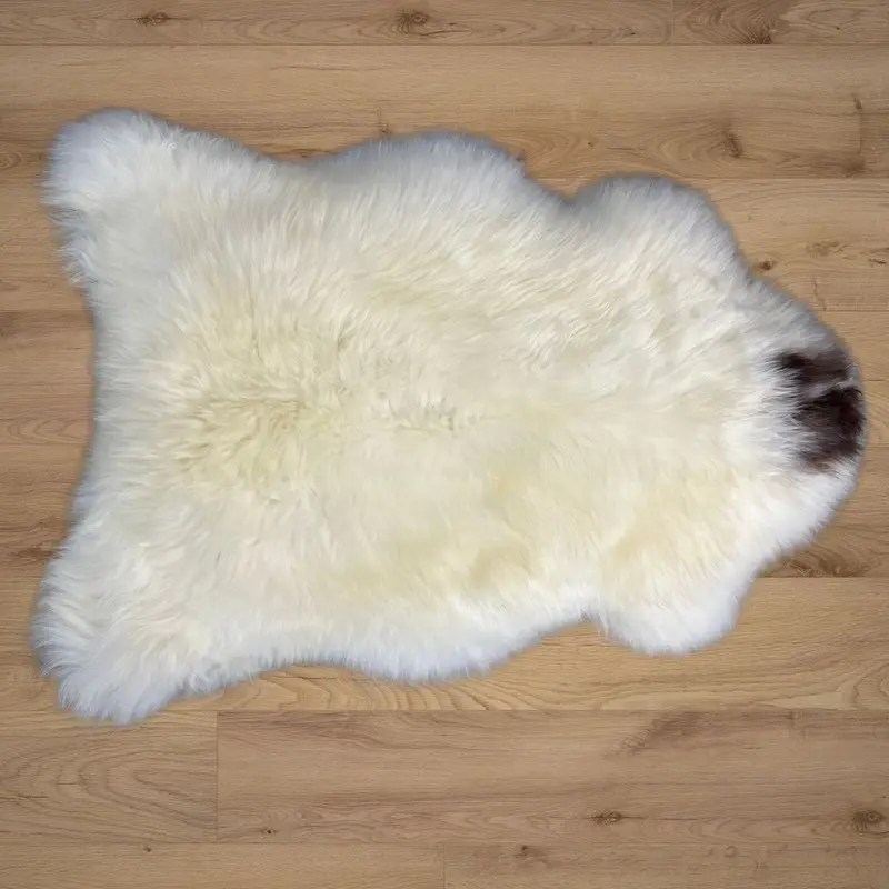 British rare breed sheepskin rug resting on a wooden floor.