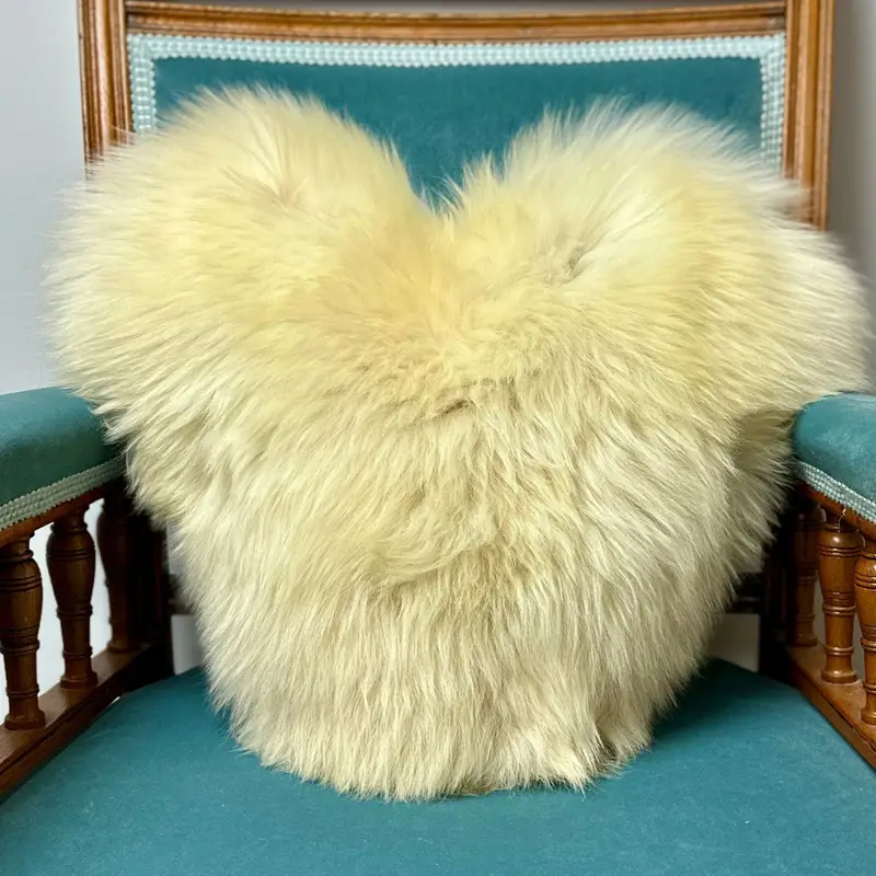 Heart shaped cushion made from British rare breed sheepskin with visible natural markings