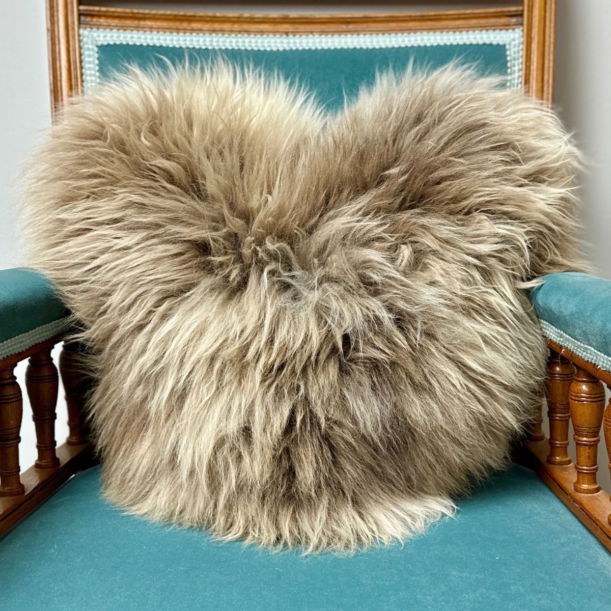 Macro detail of a British rare breed sheepskin heart cushion showing natural fleece texture