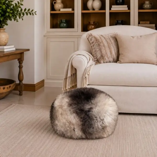 Handmade rare breed sheepskin pouffe showing its natural mix of cream, brown and taupe medium wool.