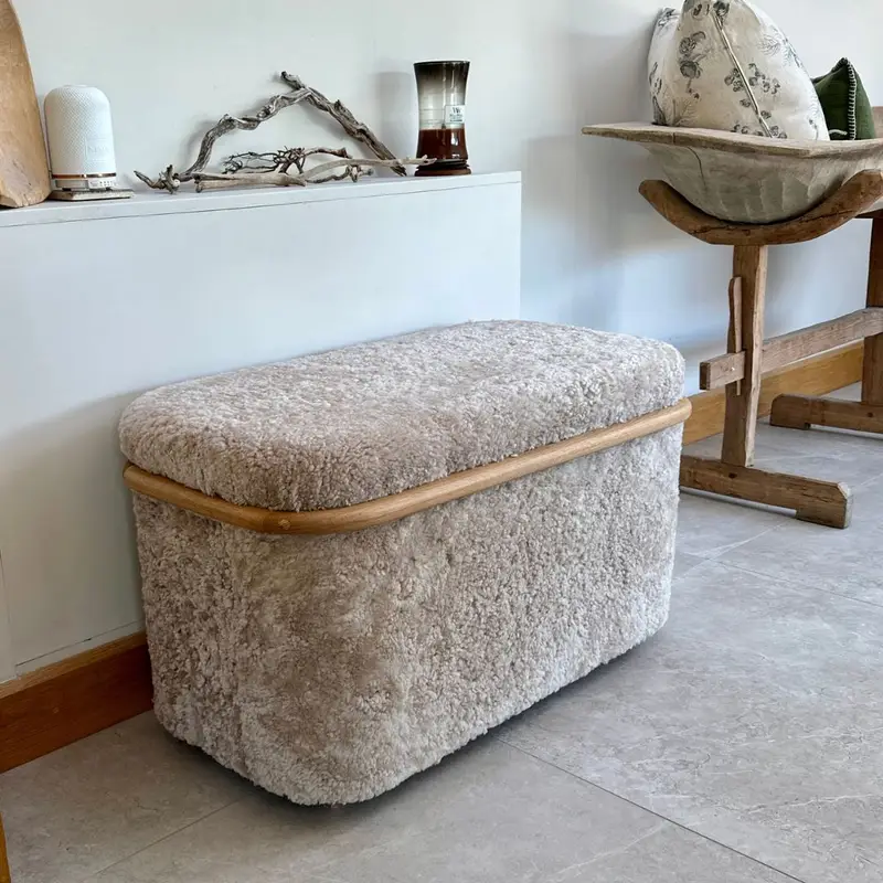 Workshop drop no. 06 Storage Ottoman Oak and sheepskin storage ottoman in a calm hallway with soft neutral decor