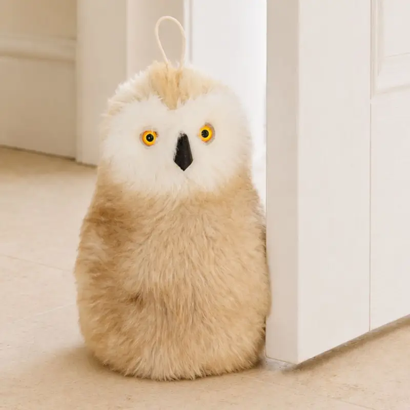 Close-up of a handmade owl sheepskin doorstop showing soft wool texture, eyes and stitched details