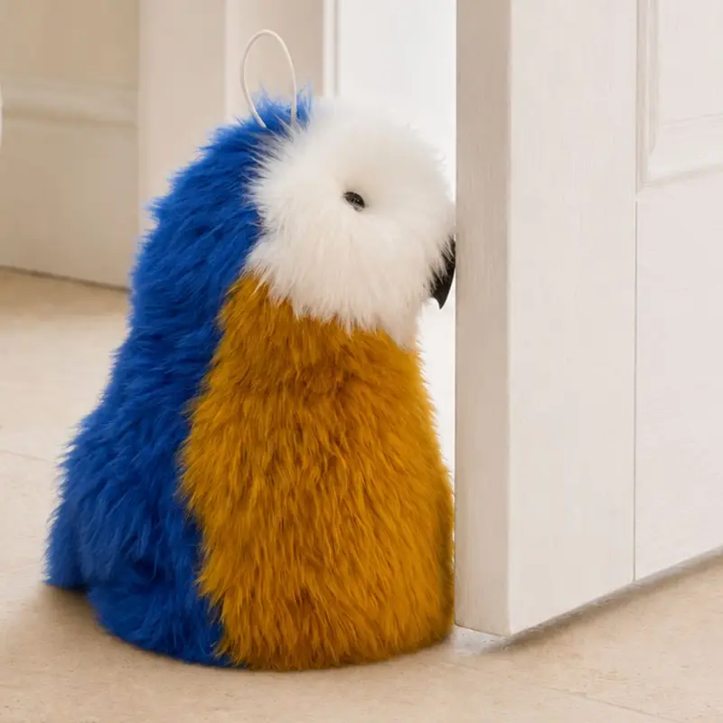 Close-up of a handmade parrot sheepskin doorstop showing colourful wool texture and characterful details