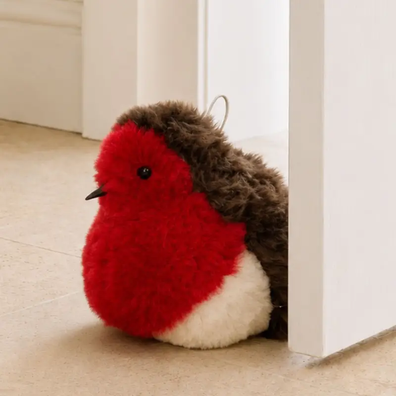 Close-up of a handmade robin sheepskin doorstop showing soft wool texture and characterful red breast detail