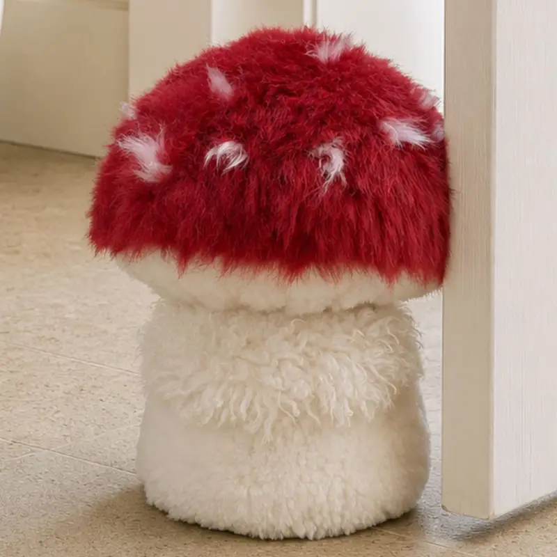 Close up of an Amanita muscaria-inspired sheepskin mushroom doorstop with detailed gills.