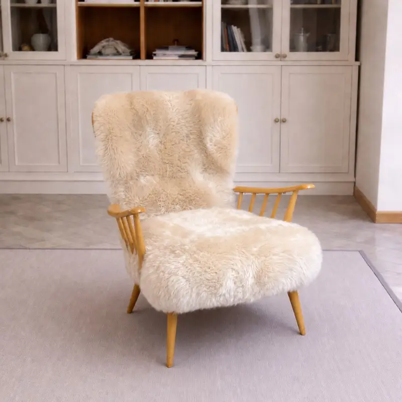 Ercol Model 766 lounge chair upholstered in pale Seashell sheepskin