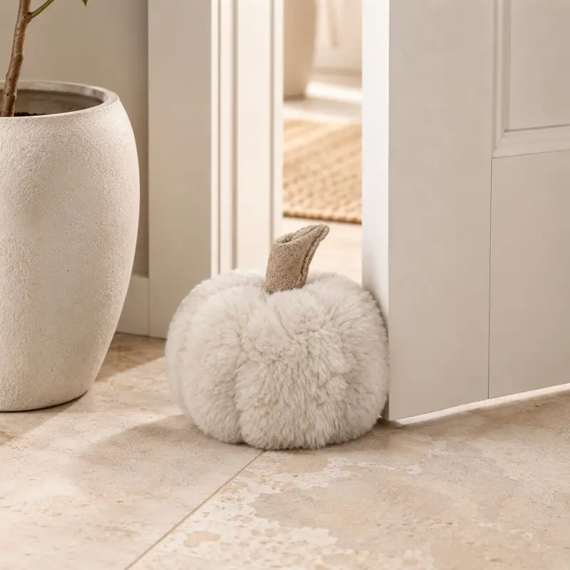 Front view of Doorkin bone coloured sheepskin pumpkin doorstop with leather stalk